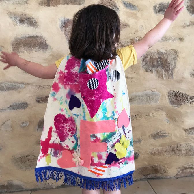 A child wearing a homemade cape