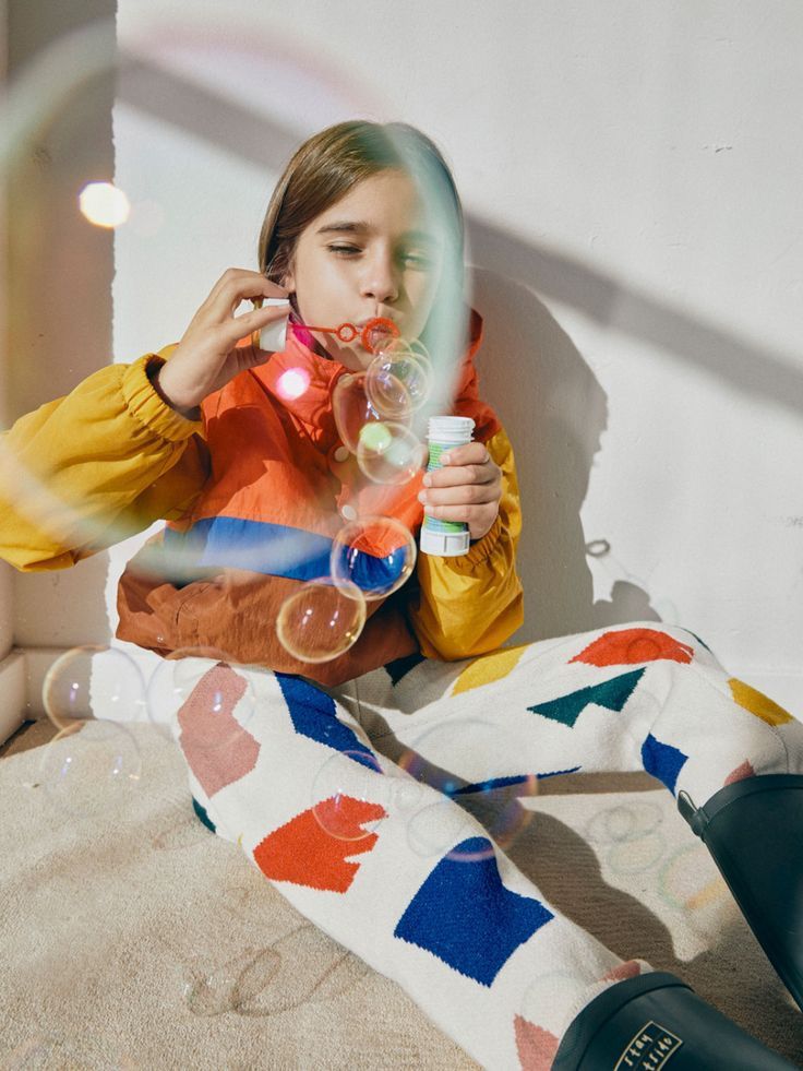 A child blowing bubbles outside